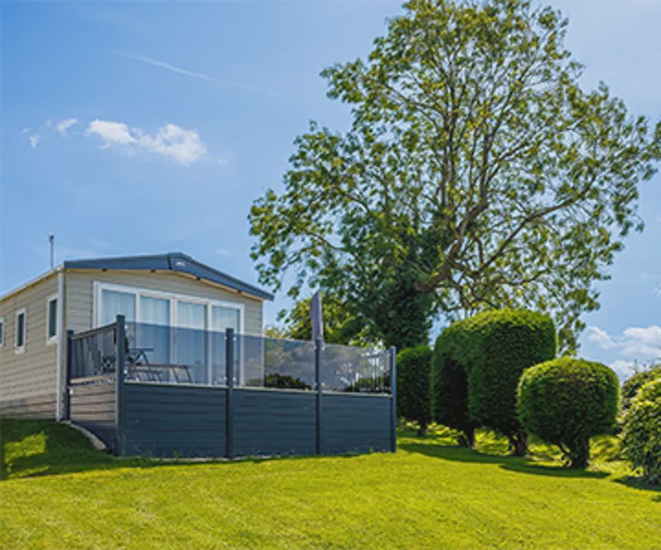 Static caravan by the fence