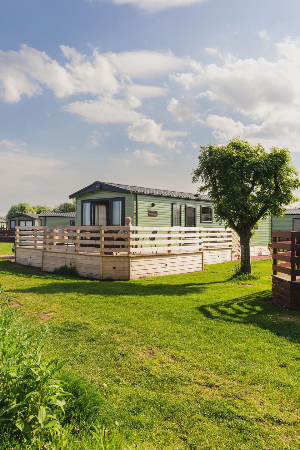 Caravan with decking on the lawn