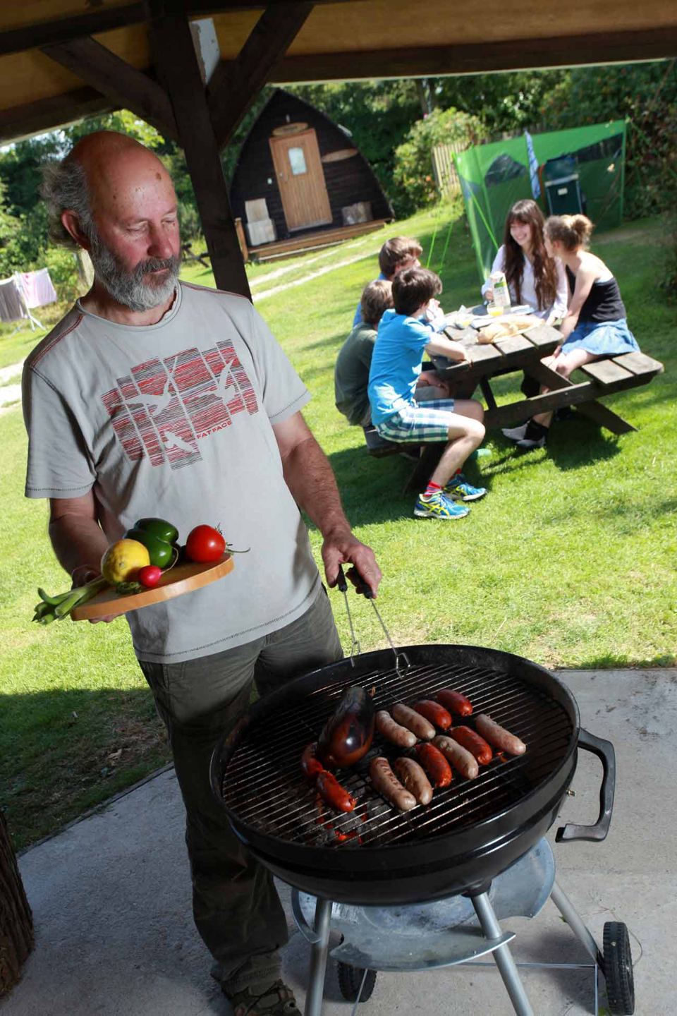 Barbecue by picnic tables