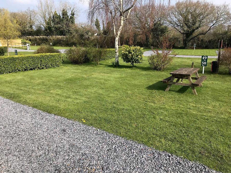 Picnic table beside the gravel pitch