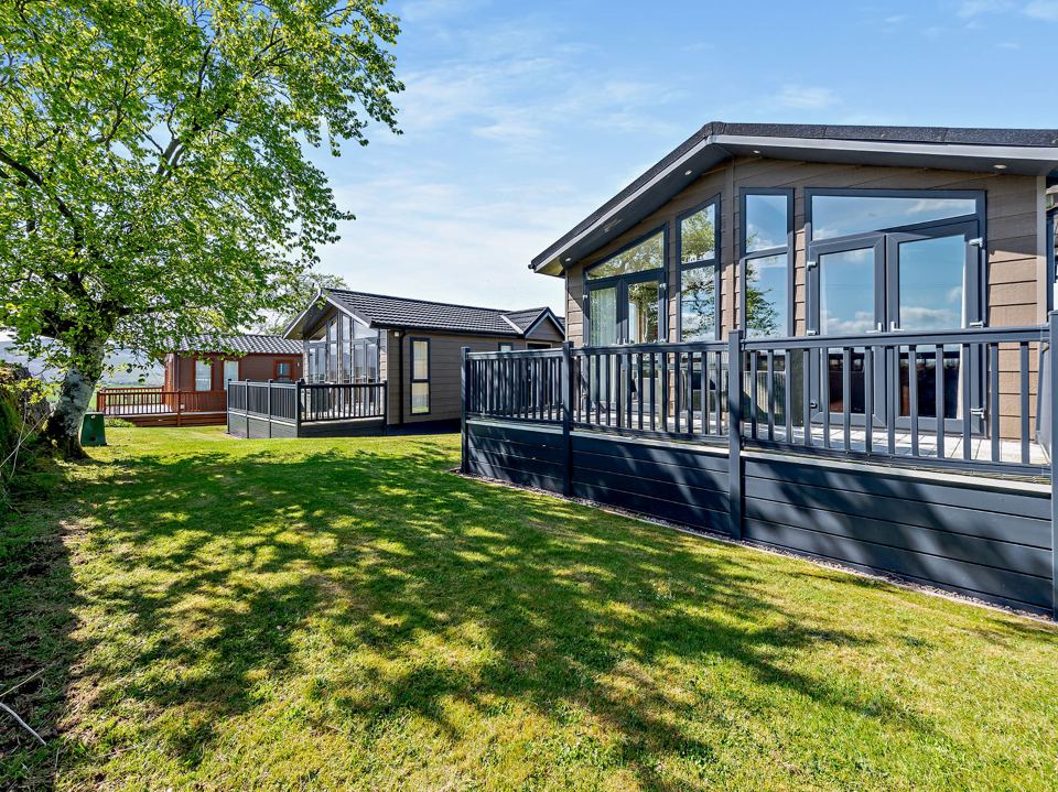Lodge with decking on the lawn