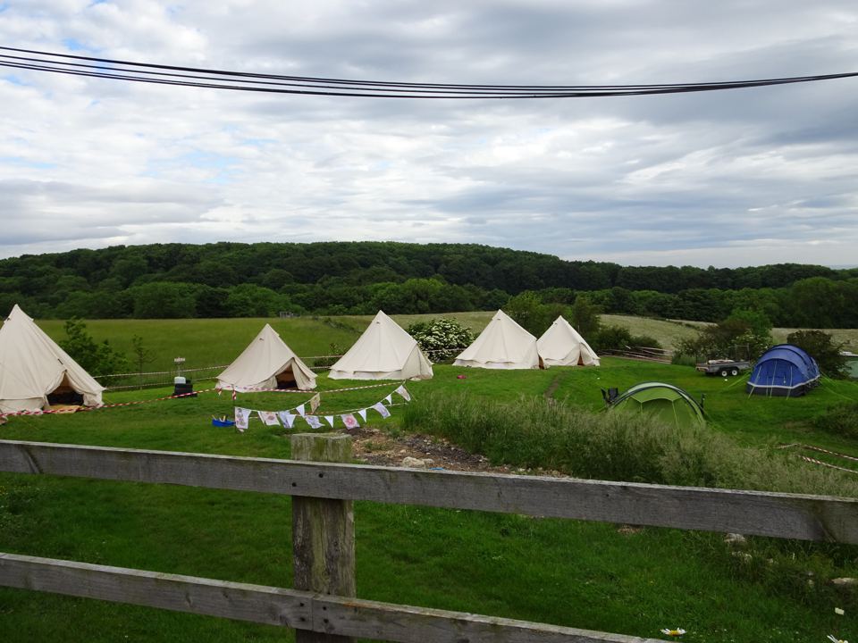 Tents above the wooded valley
