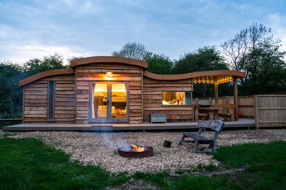 Cabin with fire pit at dusk