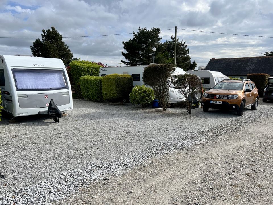 Caravans and car on gravel pitches