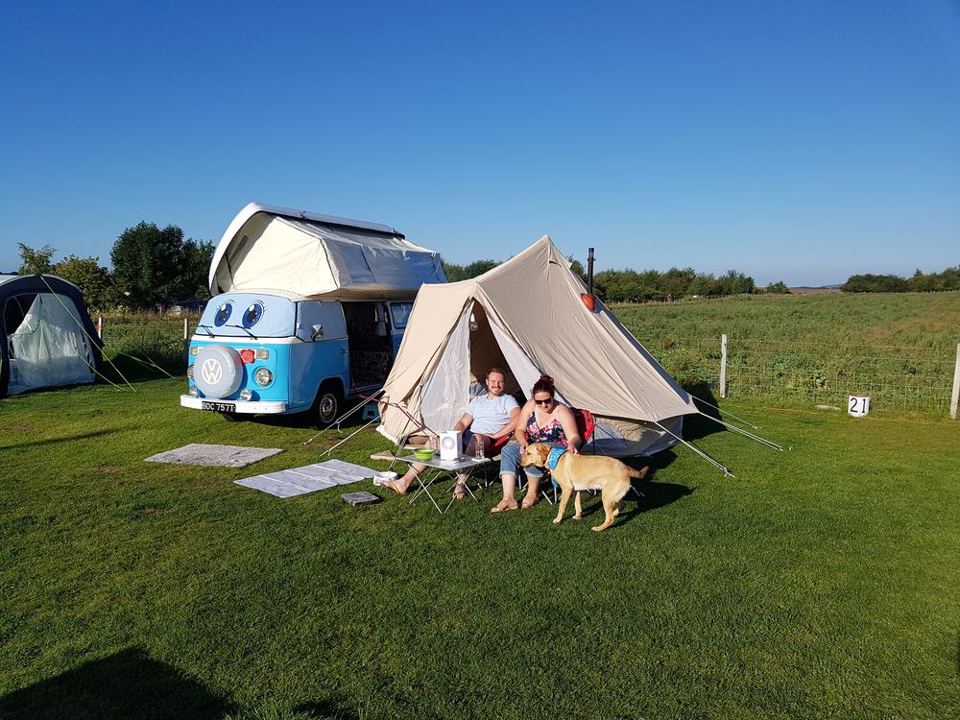 Campervan and tent on grass