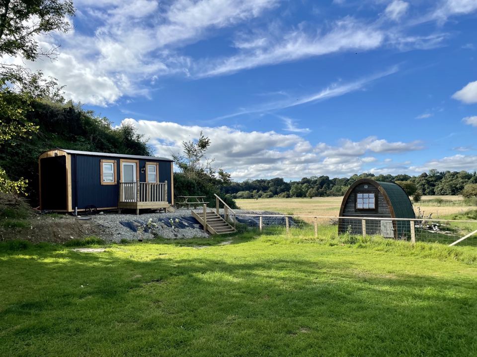 Shepherd's hut and pod in the field