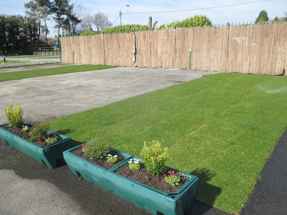 Empty pitch with flower troughs