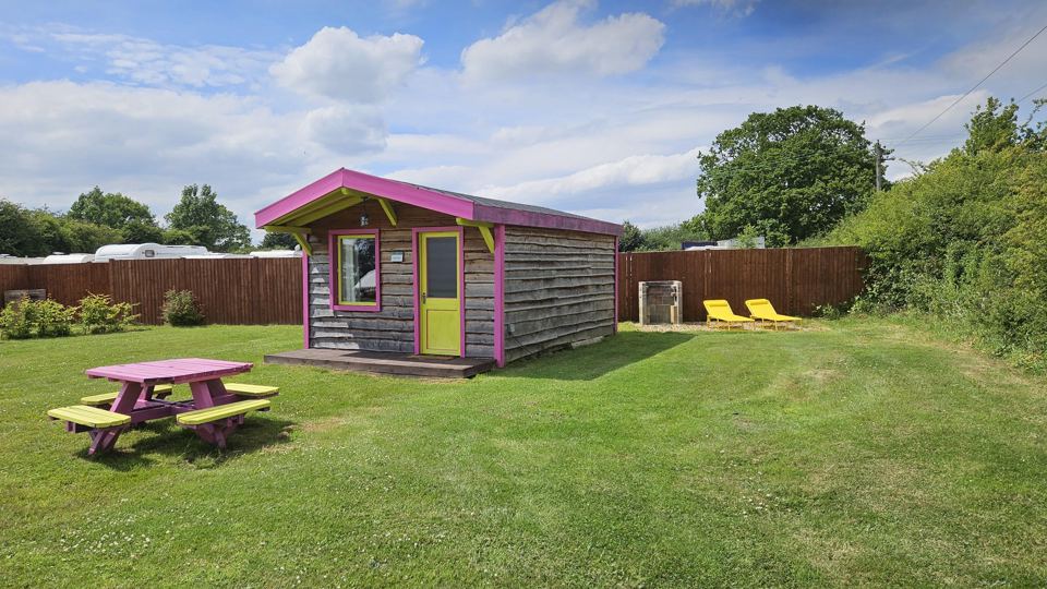 Glamping cabin with picnic bench