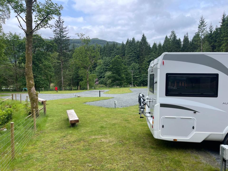 Touring pitch with forest backdrop