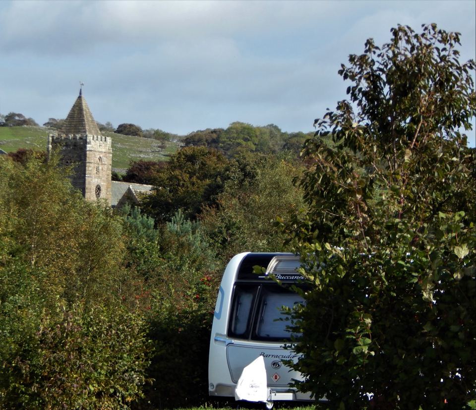 Pitch with church tower beyond