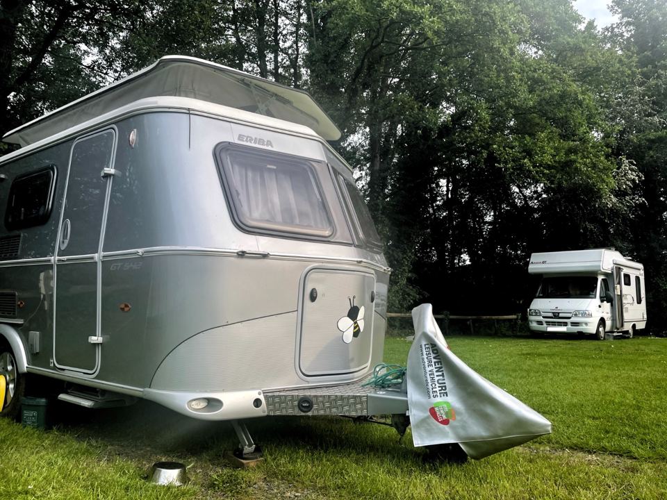 Caravan and motorhome on grass