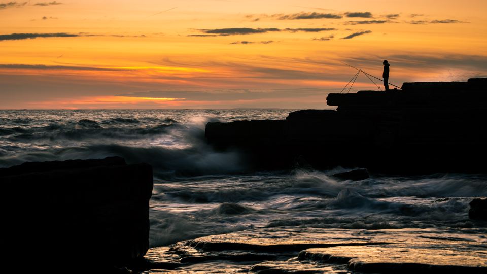 Sunset over the rocky shore