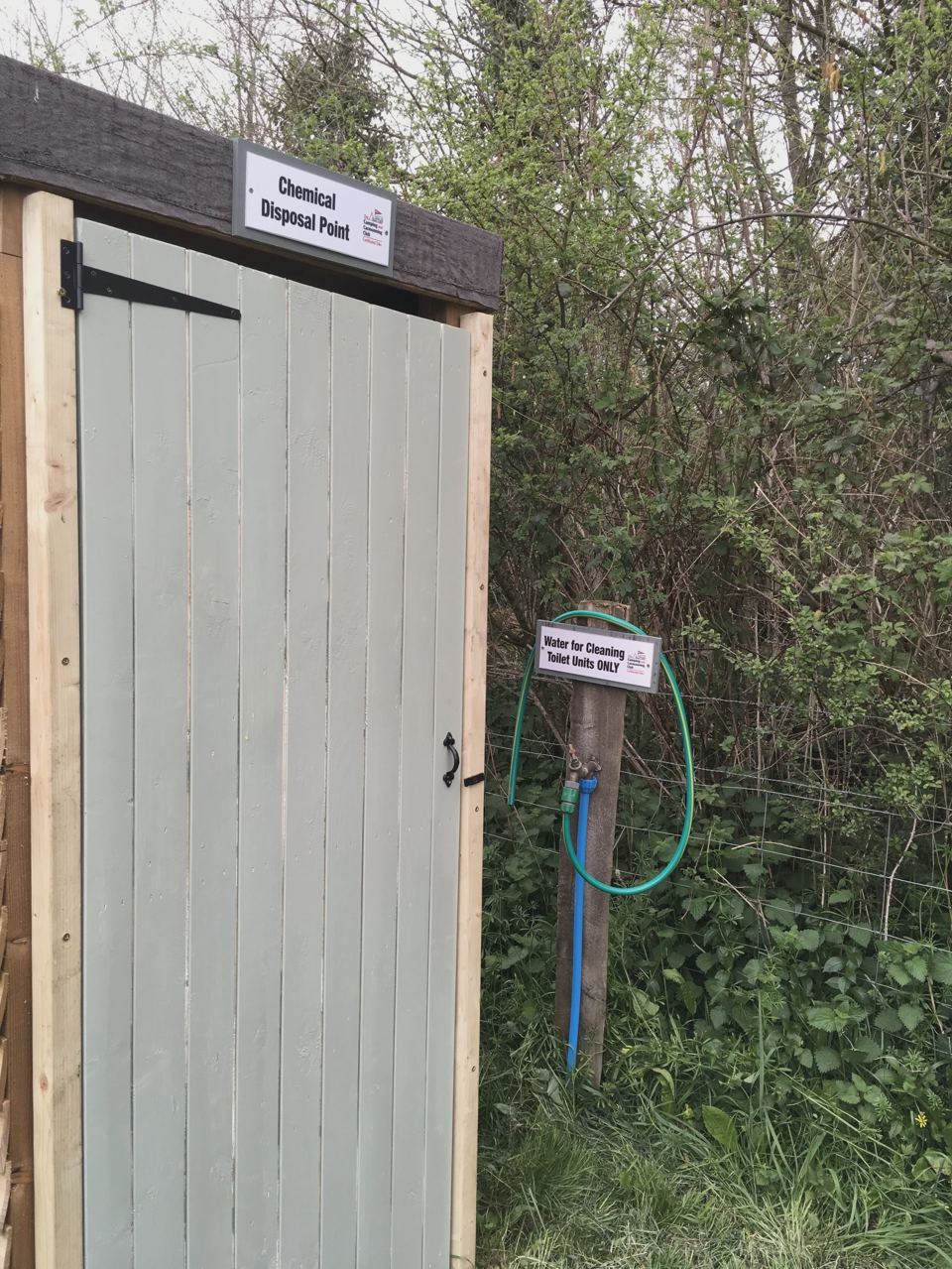 Toilet door in the hedge