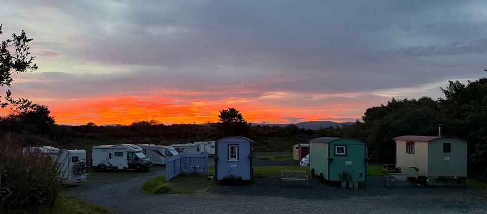 Huts and vans at sunrise