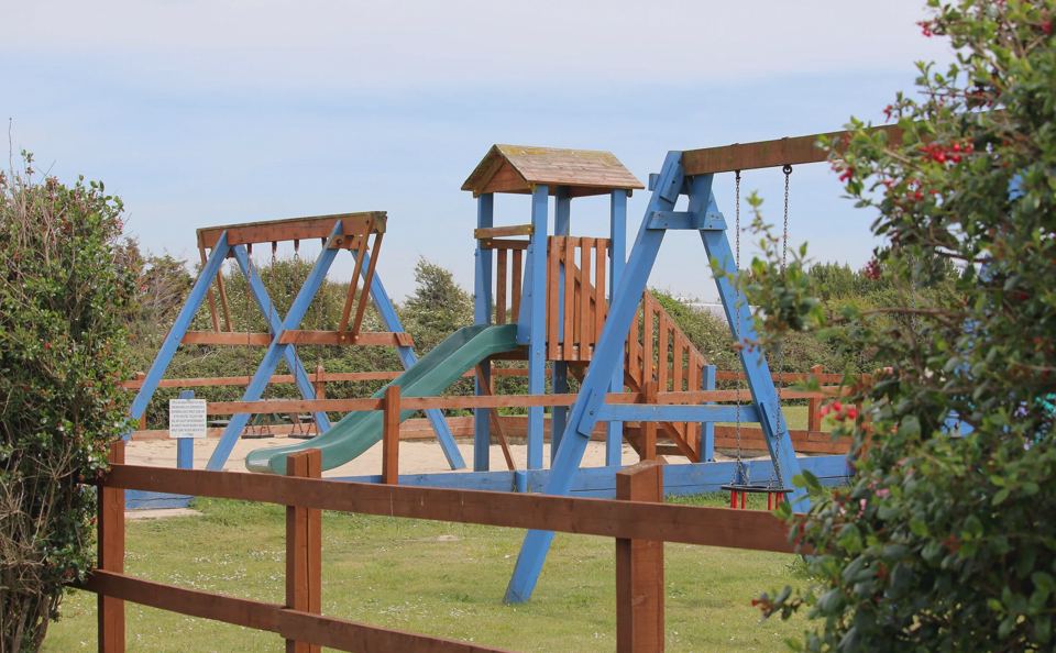 Play area with slide and swings