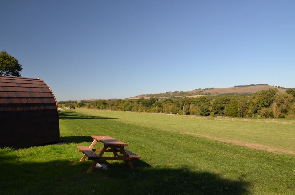 Grass field with pod beyond