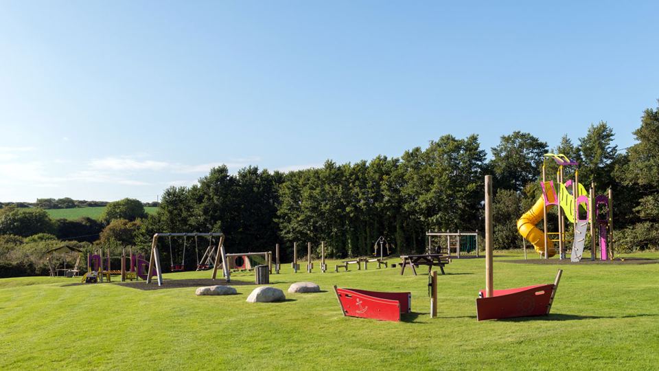 Play area with slide and swings