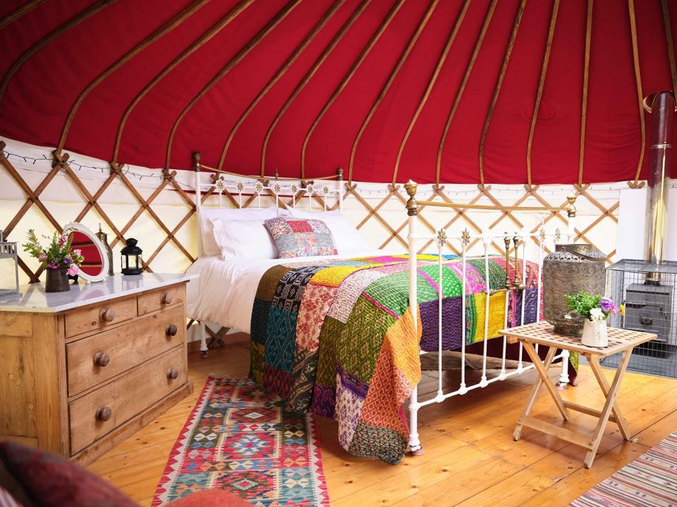 Yurt bedroom with patchwork quilt