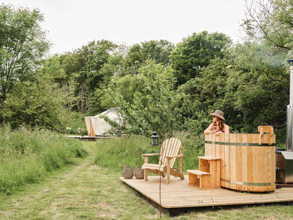Hot tub on decking beside a yurt