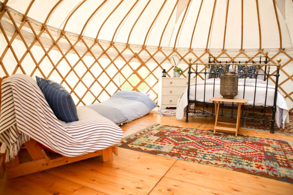 Yurt interior with bed and sofa