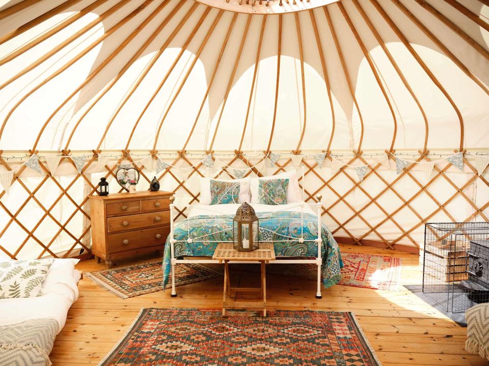 Yurt interior with bed and rugs
