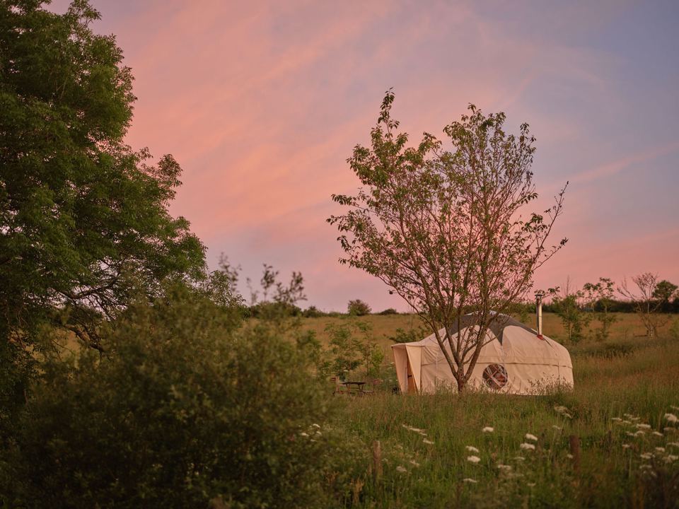 Yurt at sunset among trees