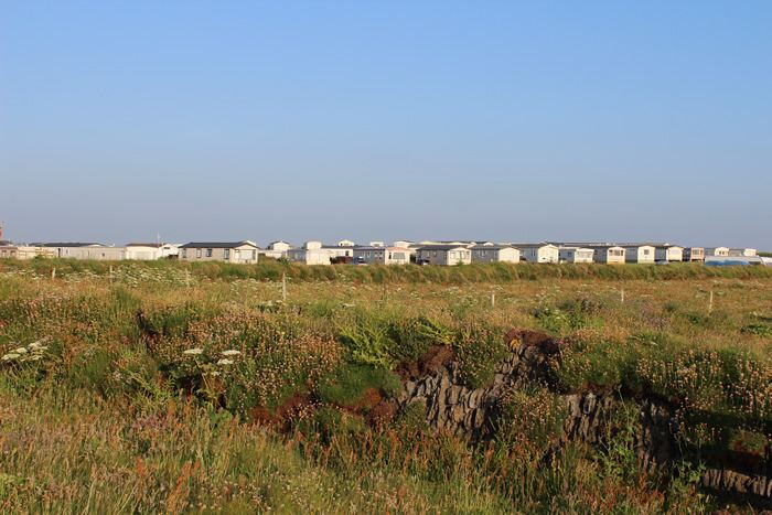 Caravans on the horizon by the field