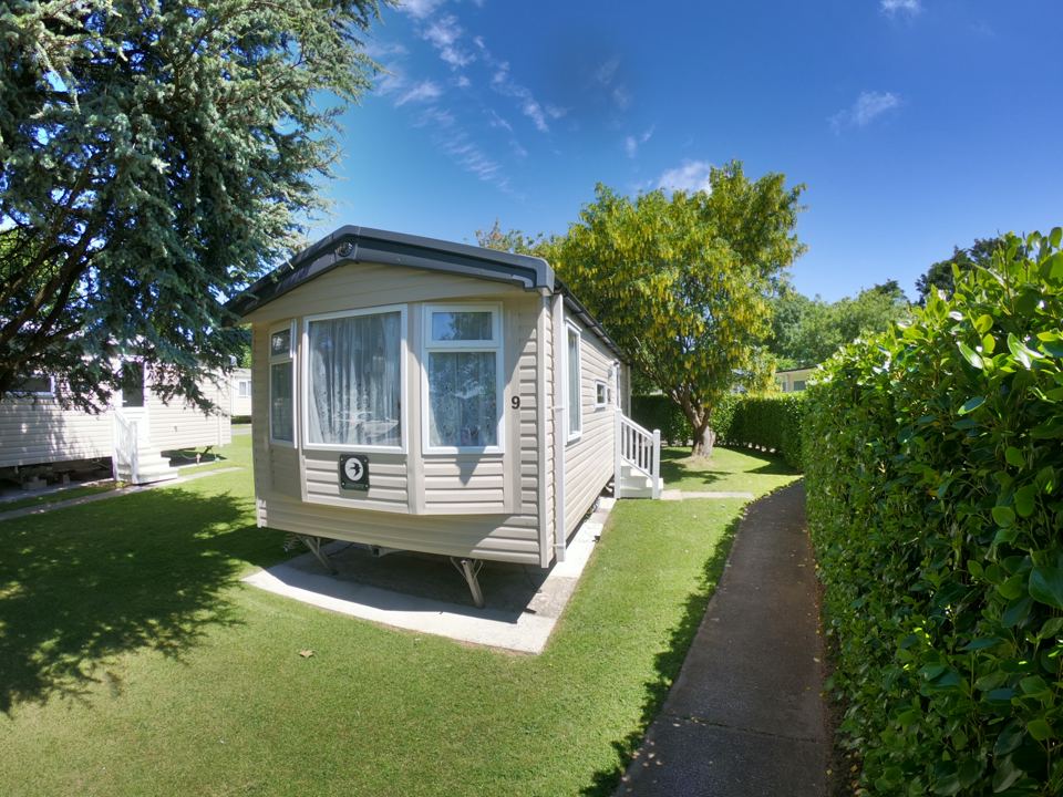 Static caravan beside the hedge