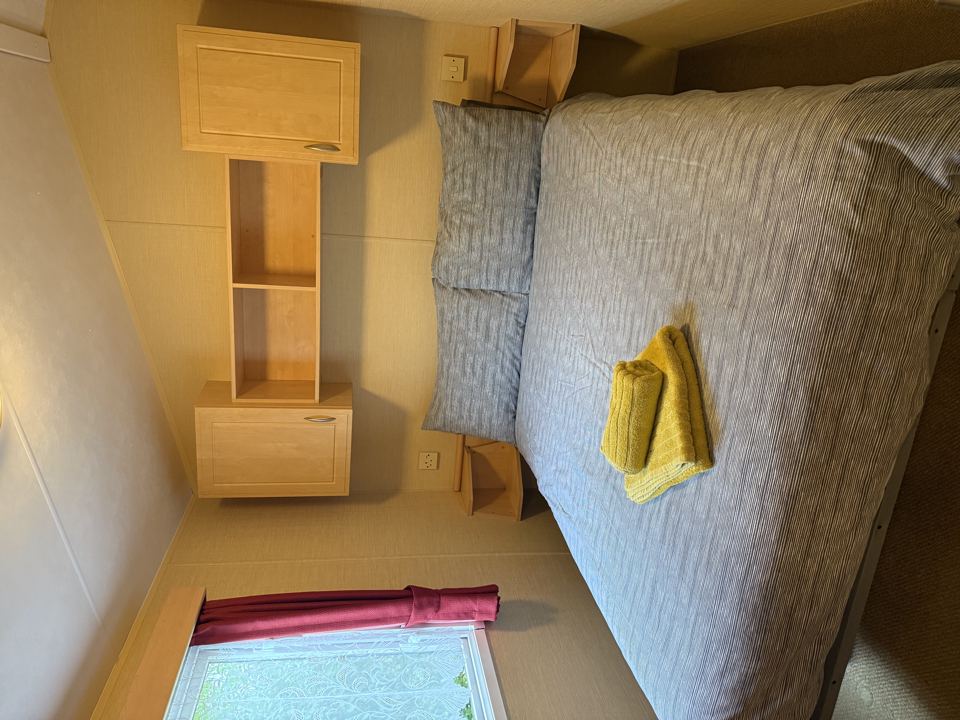 Small bedroom with bed and shelves