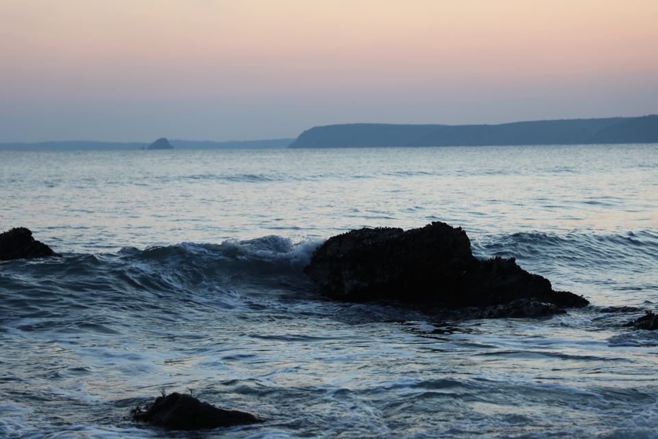 Waves on the rocks at dusk