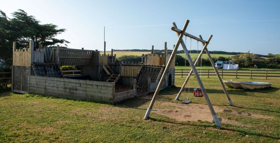 Play area with swings and climbing frame