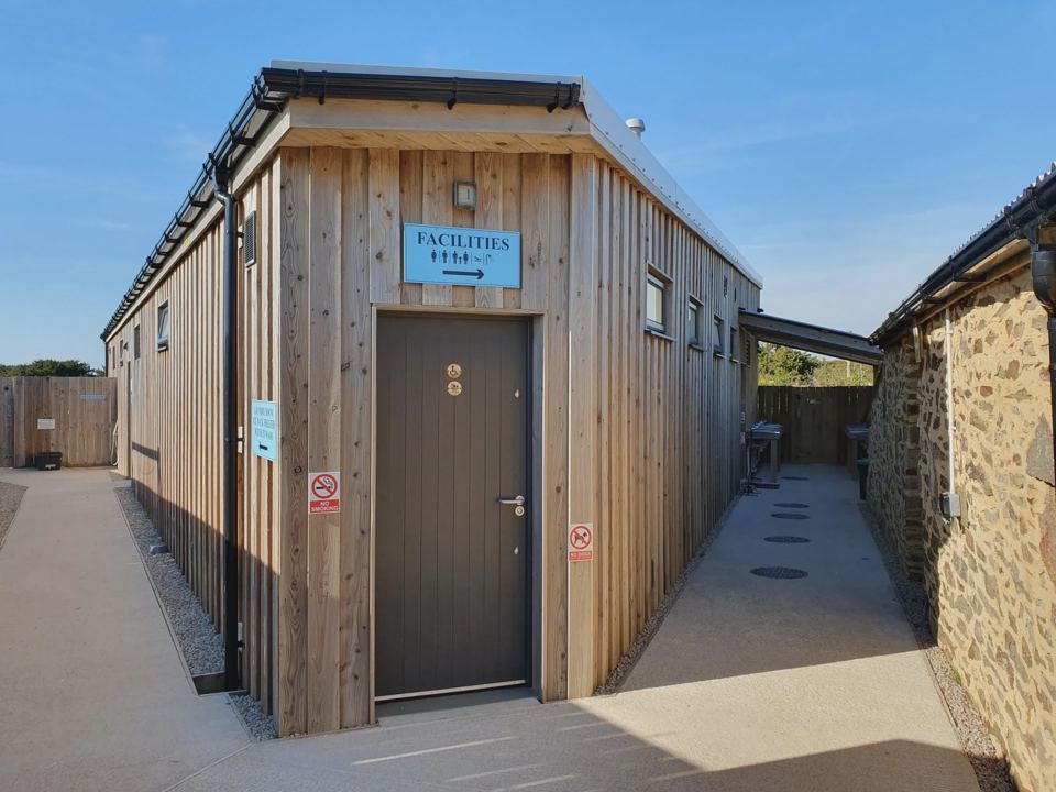 Toilet block with wooden cladding