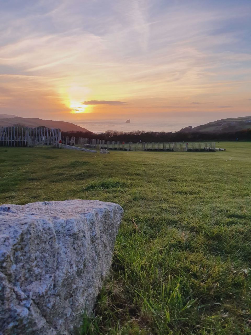 Sunset over the grass field