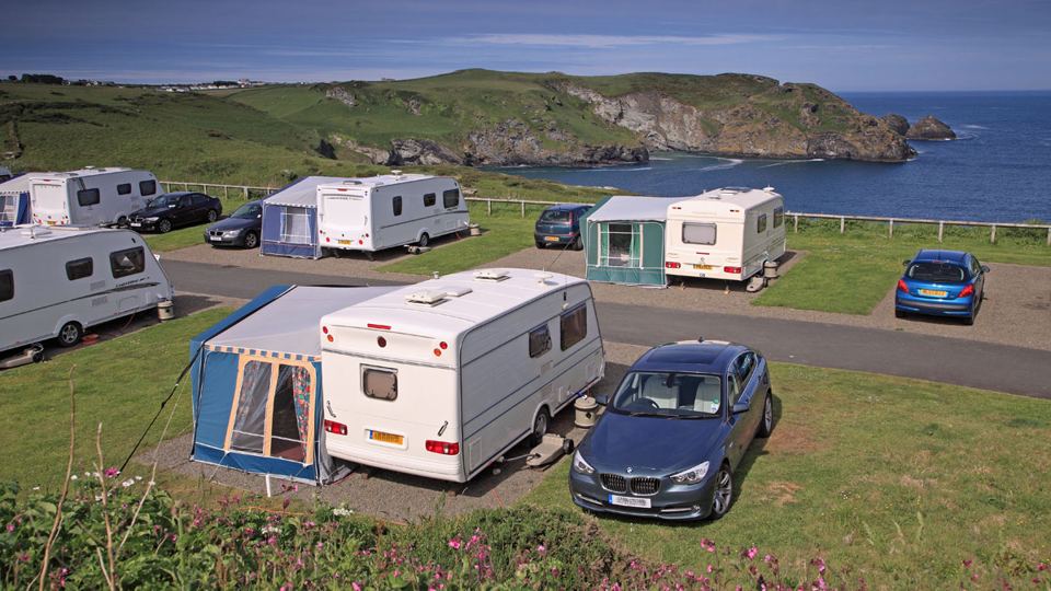 Caravans on pitches above the bay