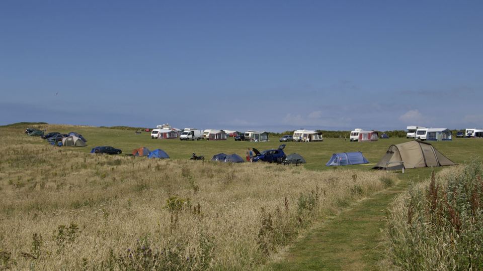 Tents and caravans across the field