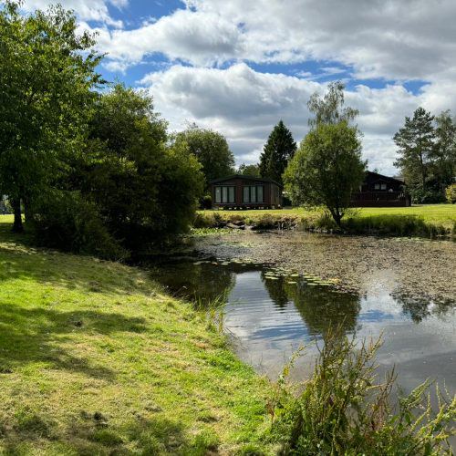 Pond with lodges beyond