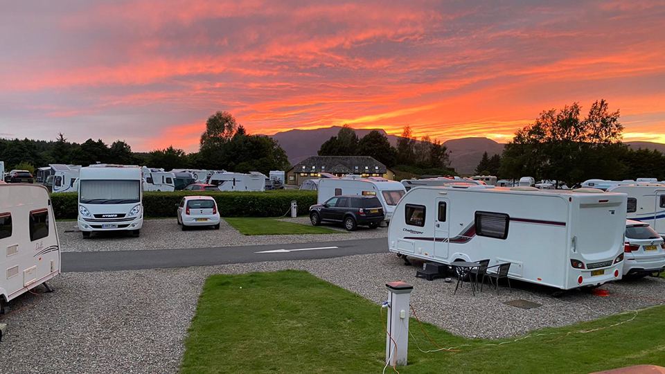 Caravans under a sunset sky