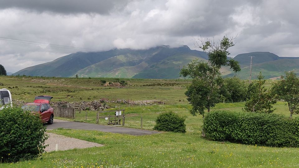 Field and trees below the mountain