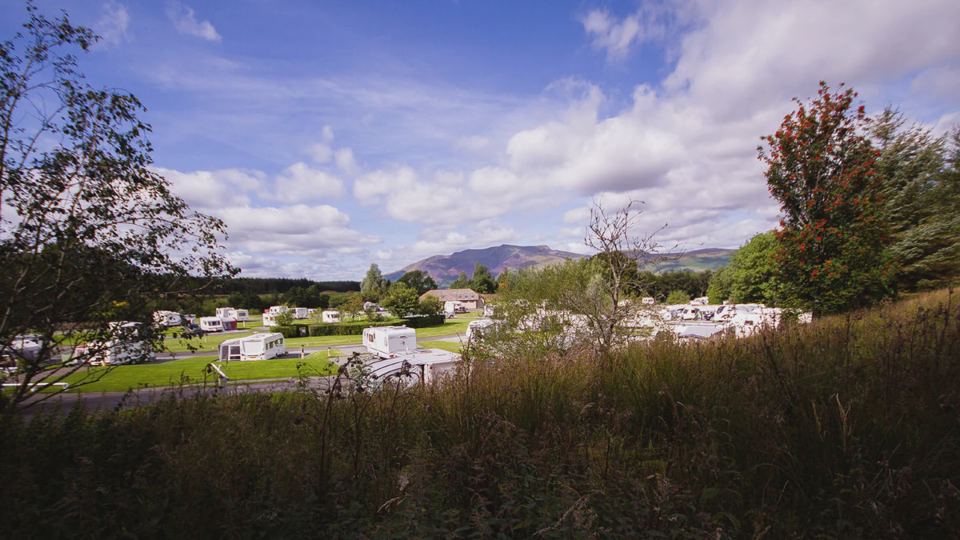 Caravans on the grass with hills