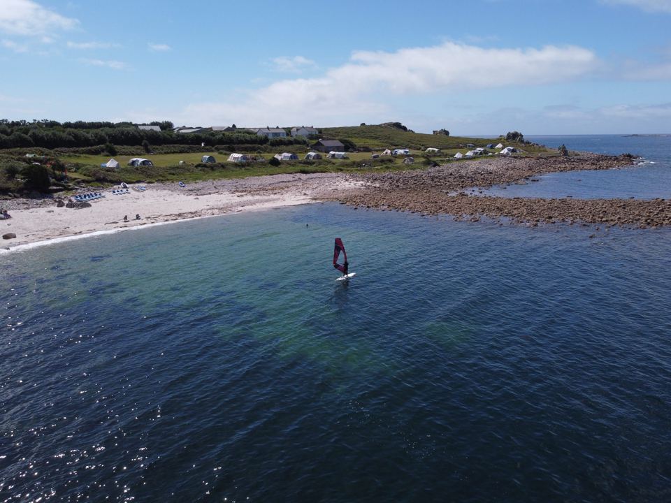 Windsurfer on the bay beside the beach
