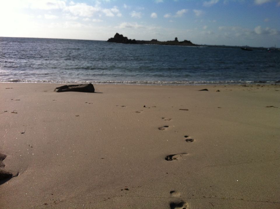 Empty beach with footprints in the sand