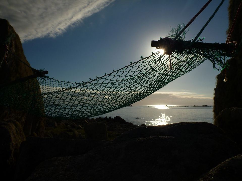 Hammock hung by the sea at dusk