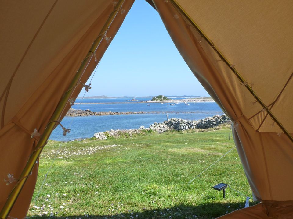 Bell tent doorway with a sea view