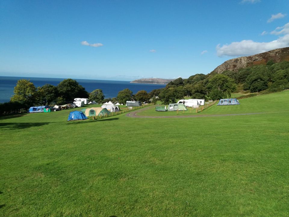 Grass field with sea beyond