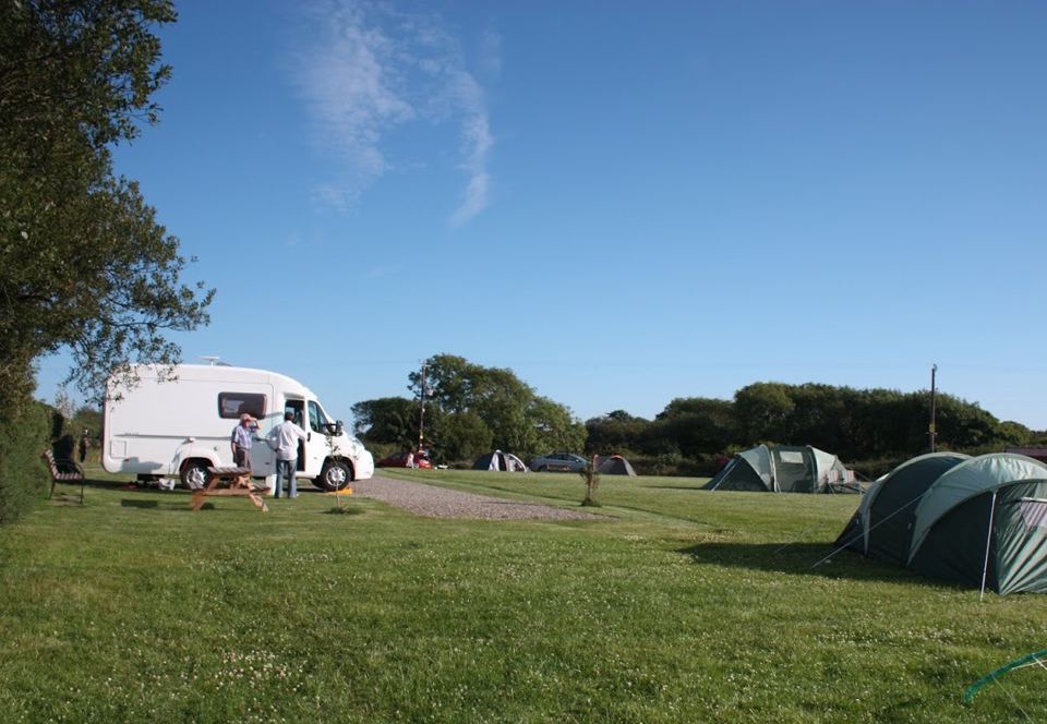 Tents and motorhome in the field