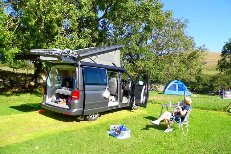 Campervan and tent on the grass