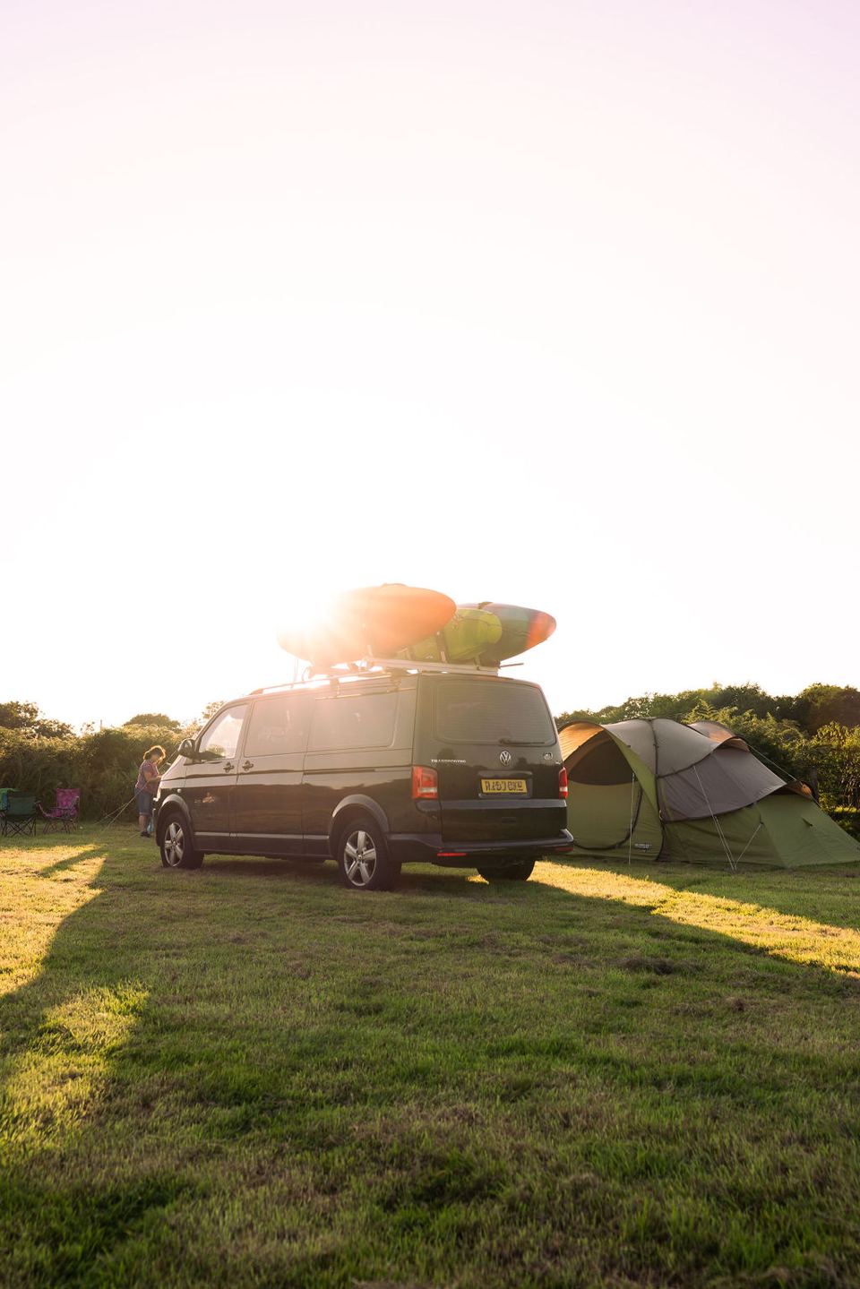 Campervan and tent at sunset