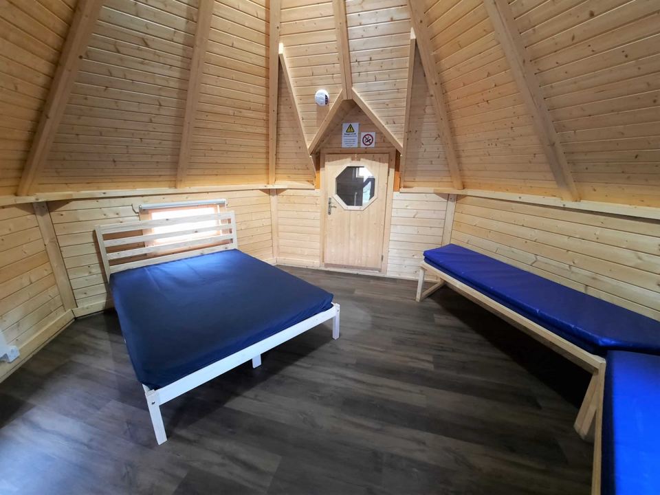 Inside a cabin with a double bed