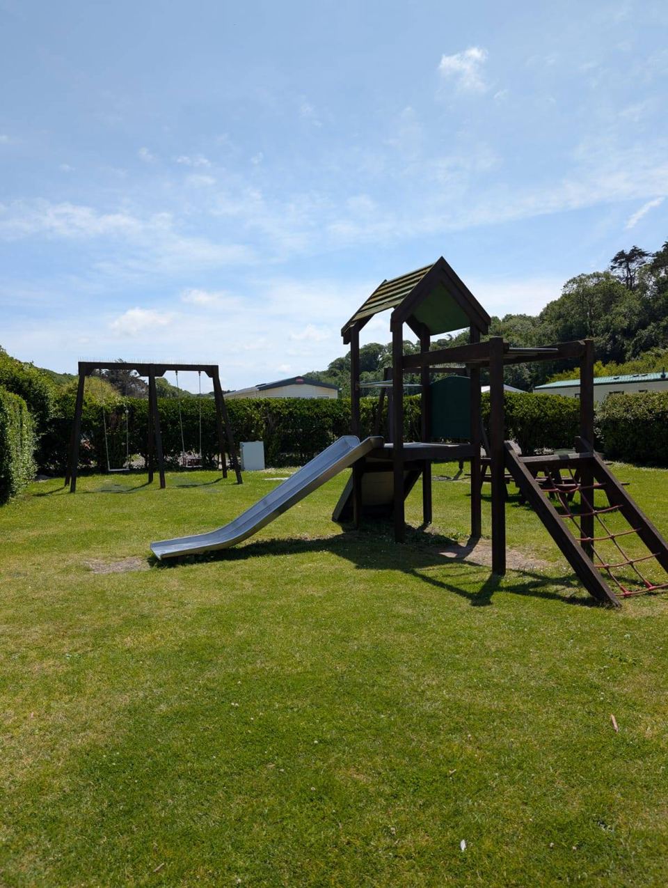 Play area with slide and swings