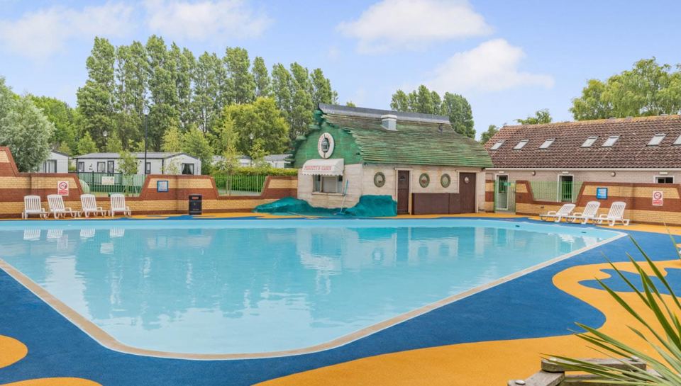 Outdoor pool beside the park buildings